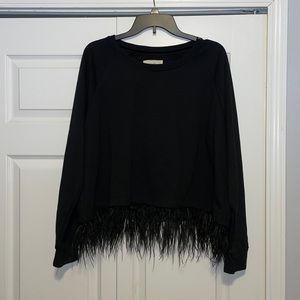 Beautiful black top with feather detail at the bottom